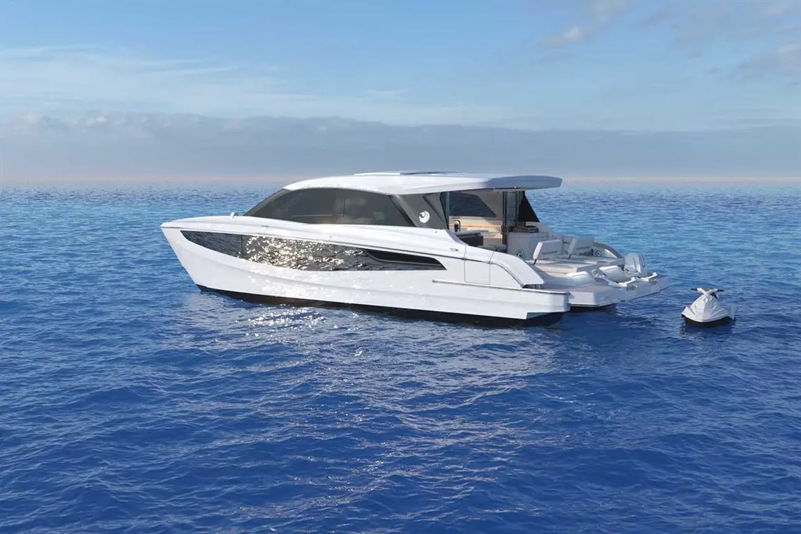 A sleek white yacht glides on calm blue waters, with a small jet ski tethered nearby under a clear sky.